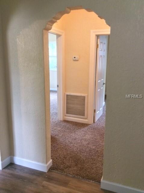 From Kitchen to Bed/Bath rooms. Walk through with decorative arch way