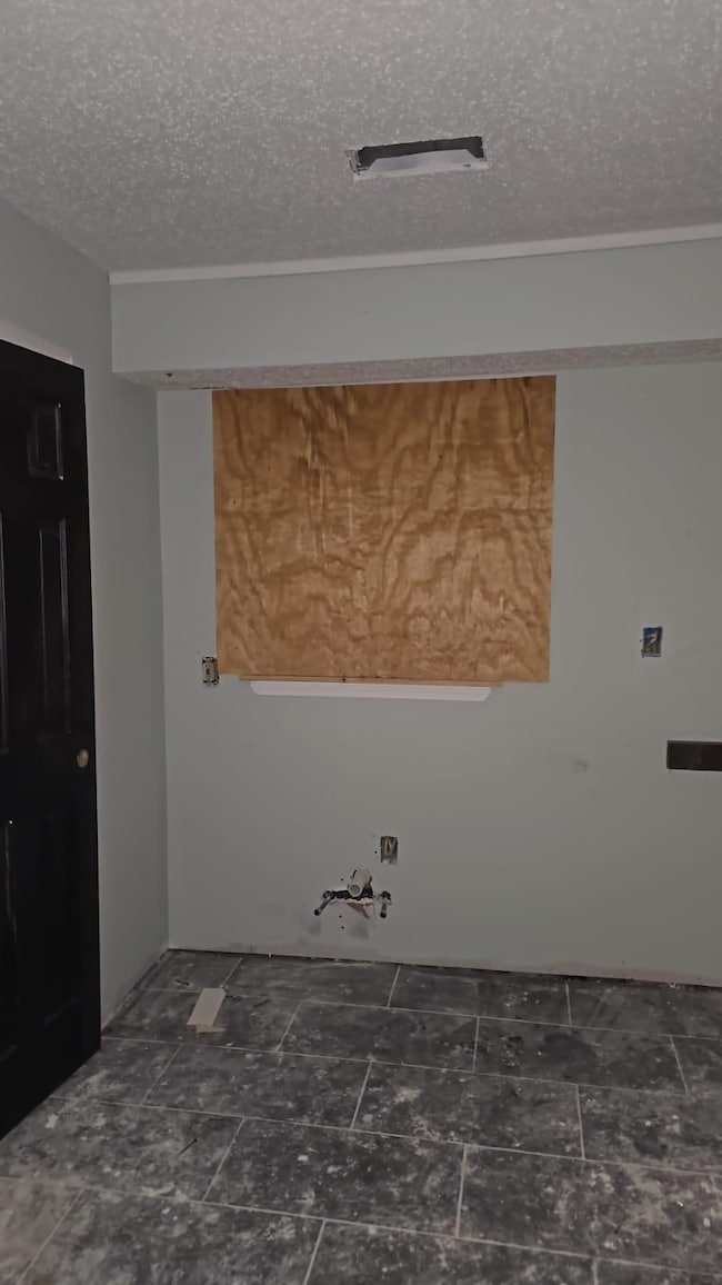 Washroom with a textured ceiling