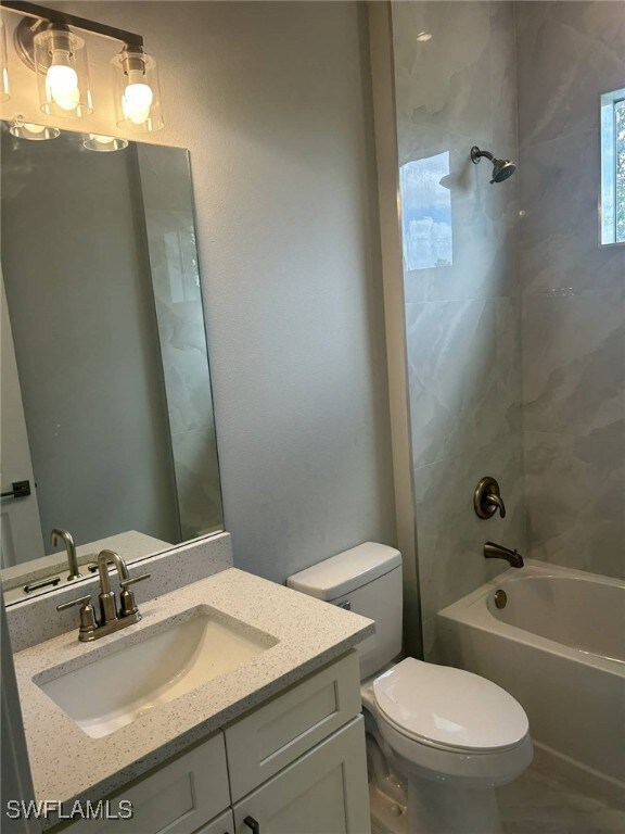 Bathroom with vanity and bathing tub / shower combination