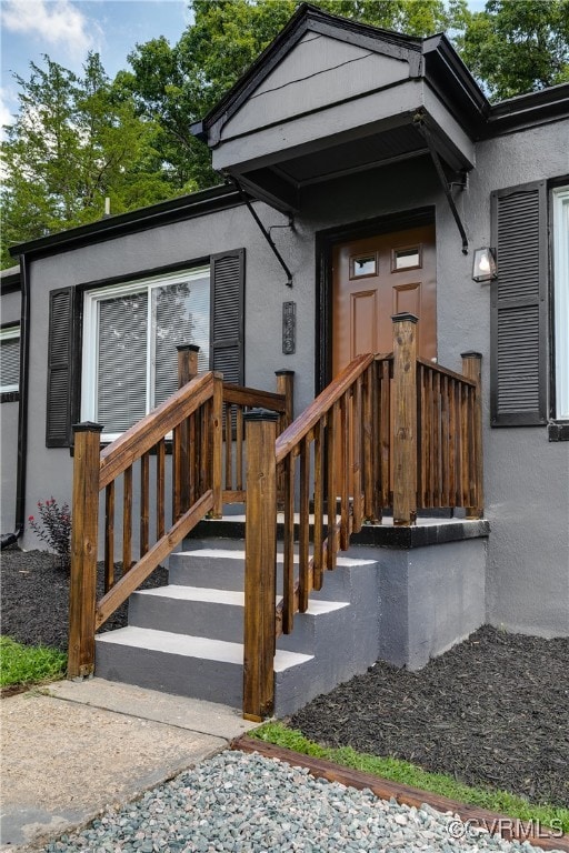 Entrance to property with stucco siding
