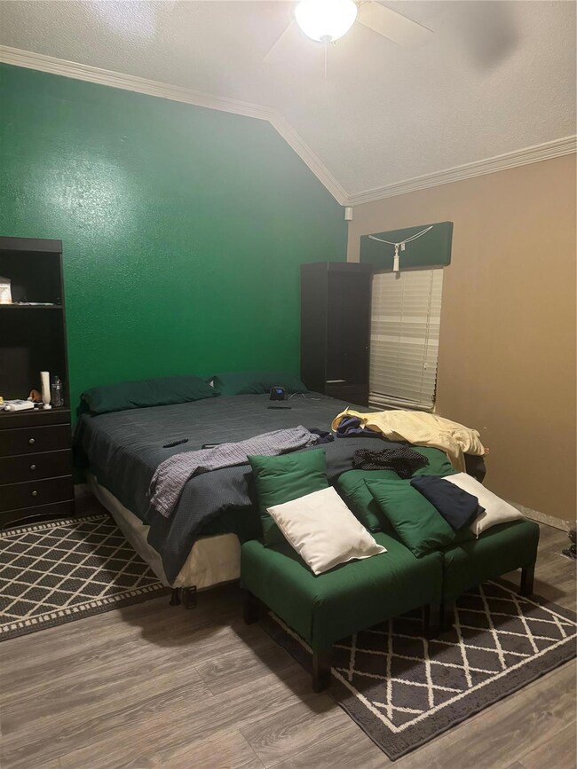 Bedroom featuring ornamental molding, hardwood / w