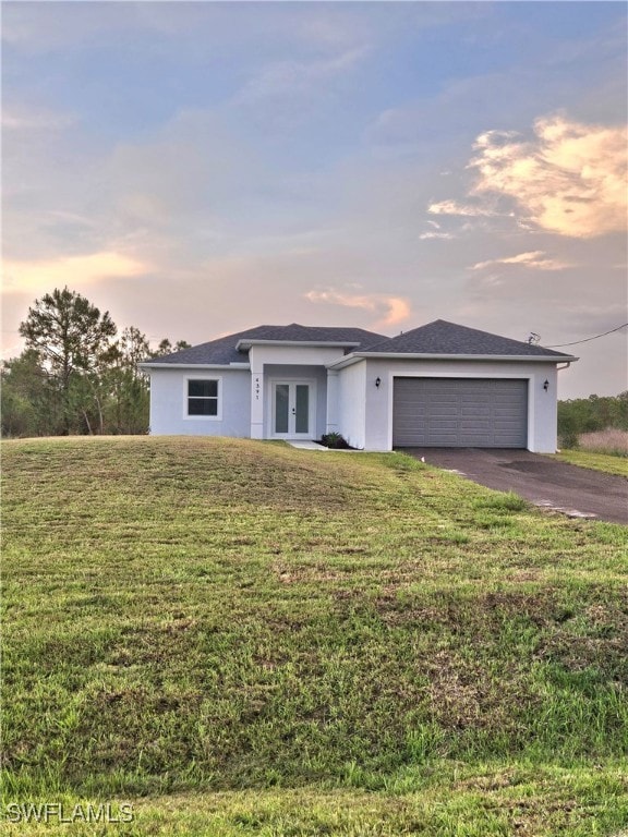 View of front of home with french doors, asphalt d