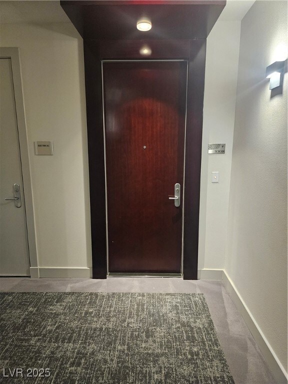 Doorway featuring baseboards