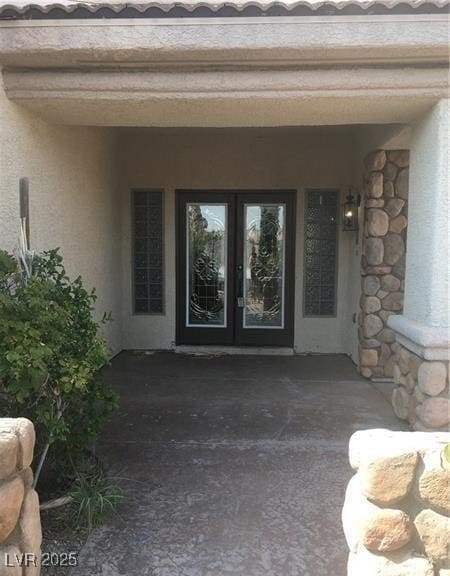 Entrance to property with french doors and stucco siding