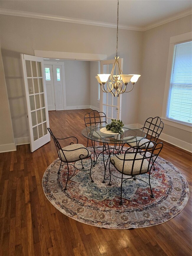 Dining space with dark hardwood / wood-style floor