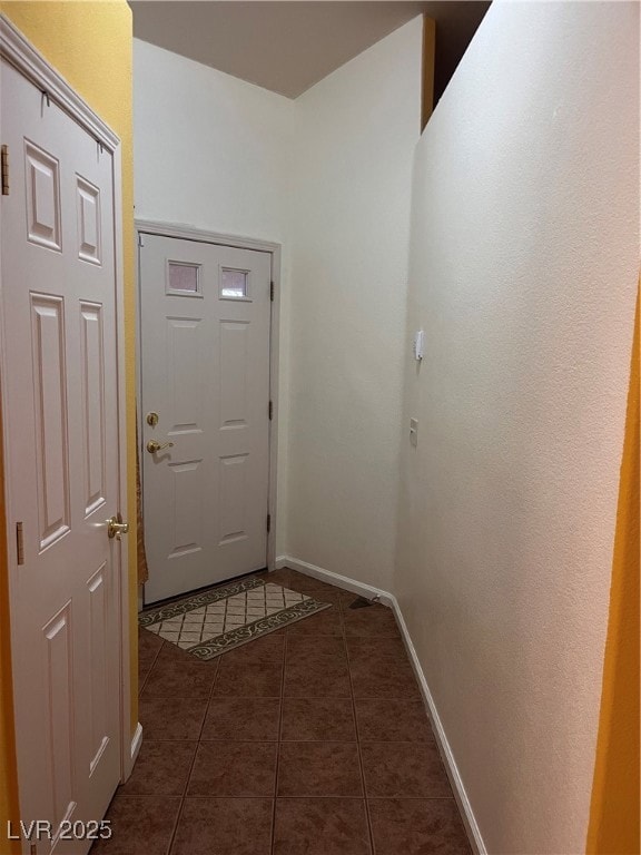 Entryway with baseboards and tile patterned floors