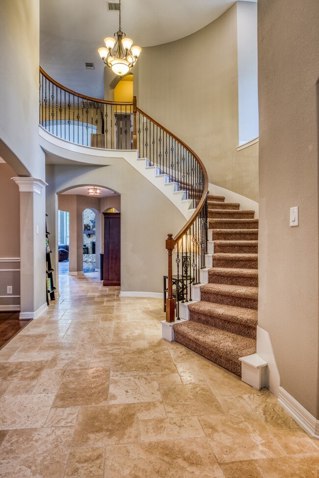 winding staircase leading the gameroom, media room, and all 3 secondary bedrooms.