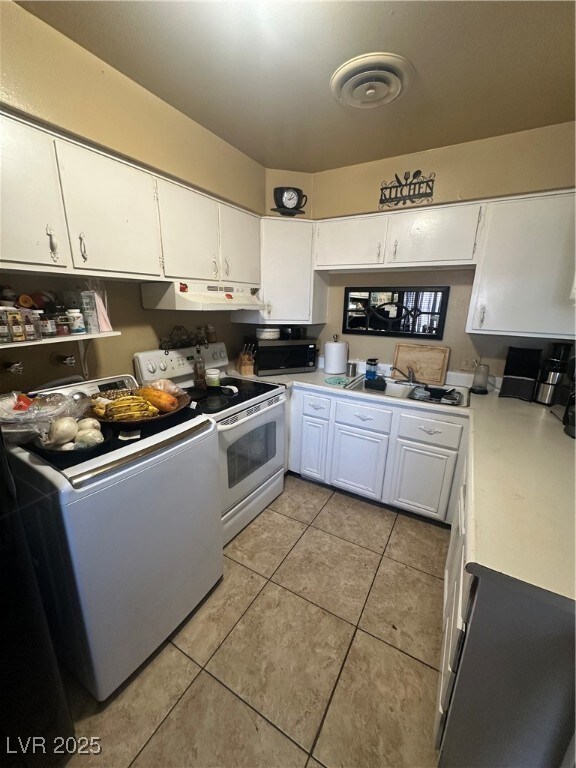 Unit A: Kitchen with range, light countertops, whi