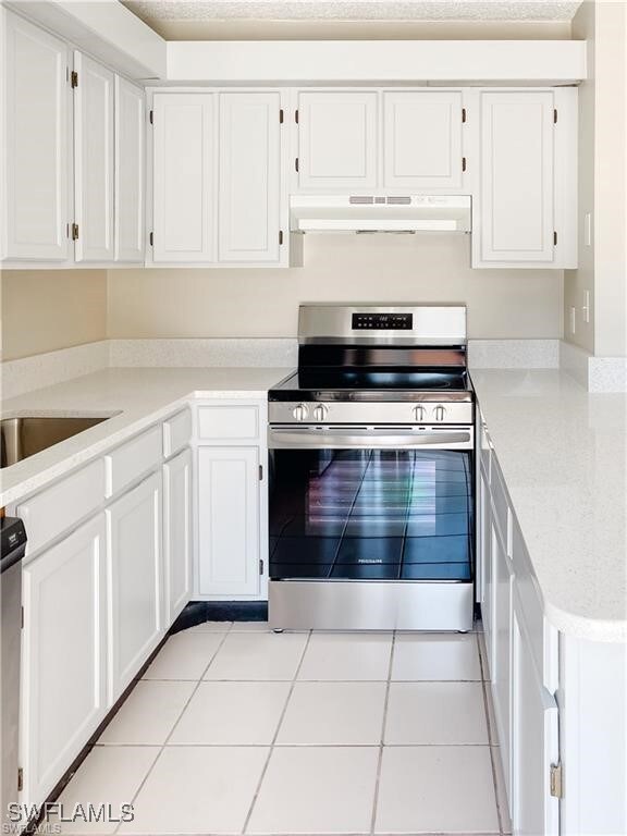 Kitchen featuring light countertops, under cabinet