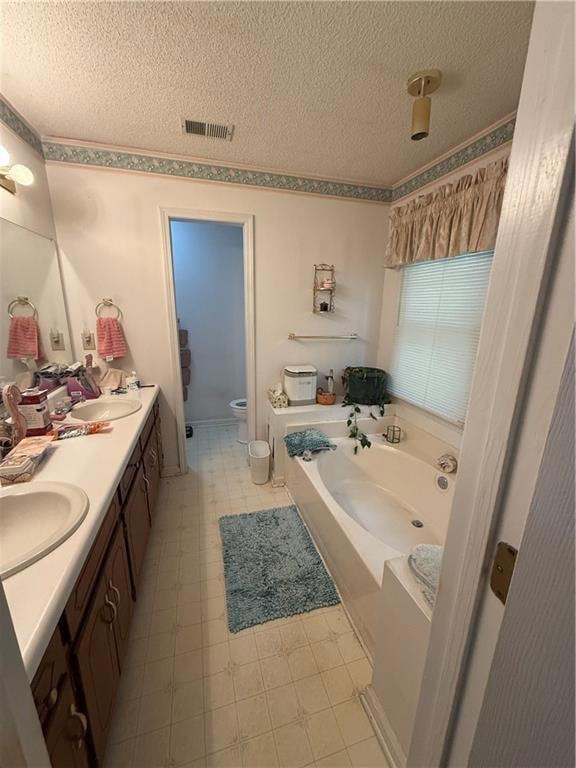 Full bath featuring a textured ceiling, toilet, vi
