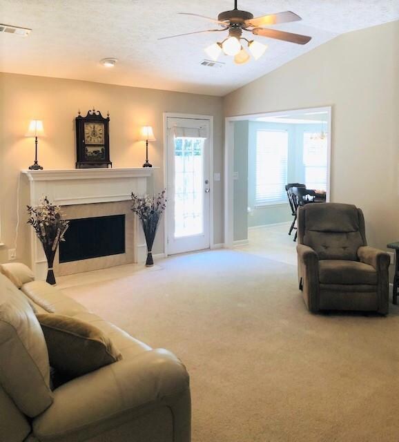 The living room has several possibilities for arranging furniture. Also leads to the backyard and kitchen. 