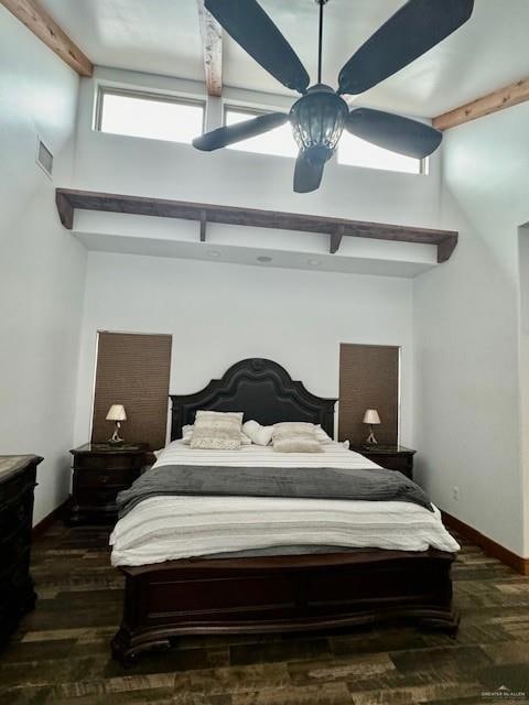 Bedroom featuring ceiling fan, beam ceiling, and hardwood / wood-style floors