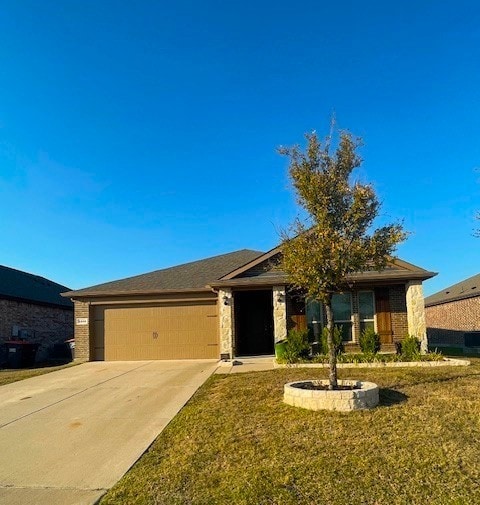 Single story home featuring concrete driveway, an attached garage, a front yard, and brick siding