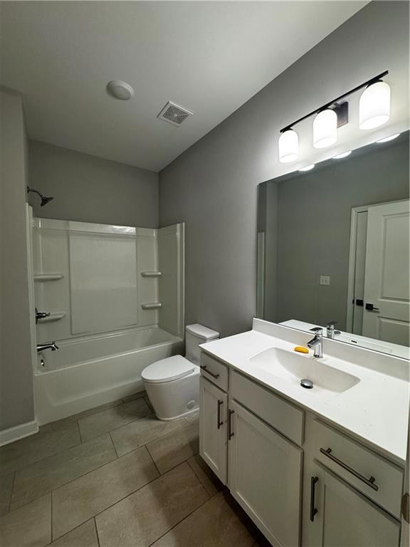 Bathroom featuring vanity, bathing tub / shower combination, and light tile patterned floors