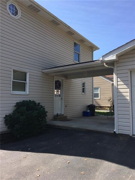 Rear covered patio connects the detached garage to