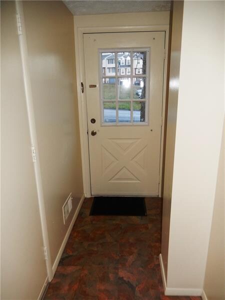 Step inside the entry with updated front door that lets in loads of light. Steps away is the entrance to the spacious garage and utility room with washer- dryer hookups and laundry sink.