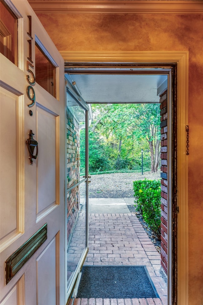 View of entryway to park-like outdoors and creek