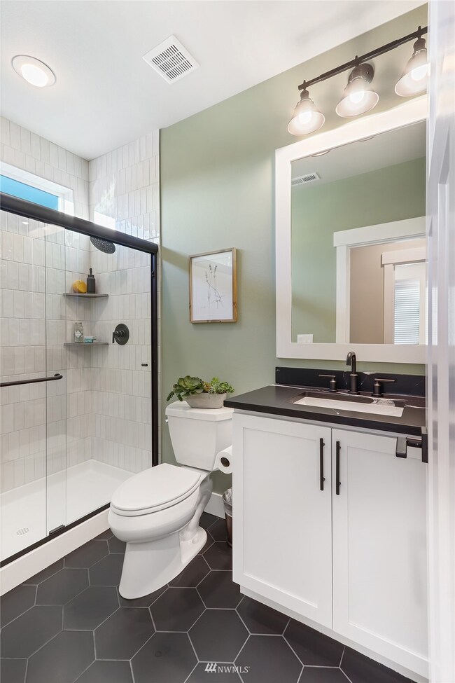 Main Floor 3/4 bath - photos of model home 3020 plan. No two homes are alike. Finishes and details will vary.