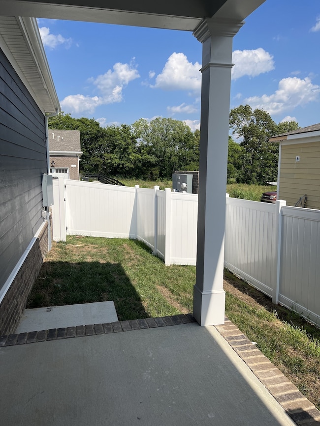 covered porch with included partial side yard fence. NOT ACTUAL HOME