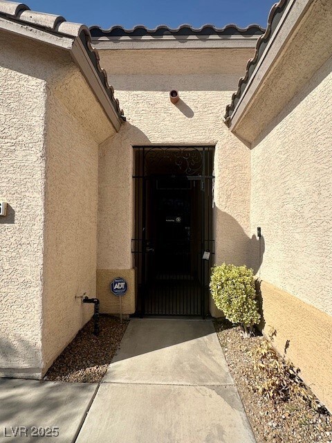 Property entrance with stucco siding