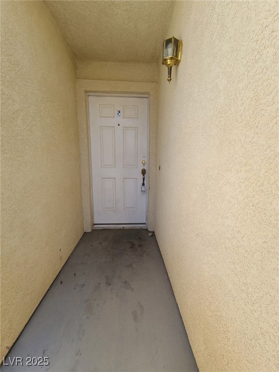 View of exterior entry with stucco siding