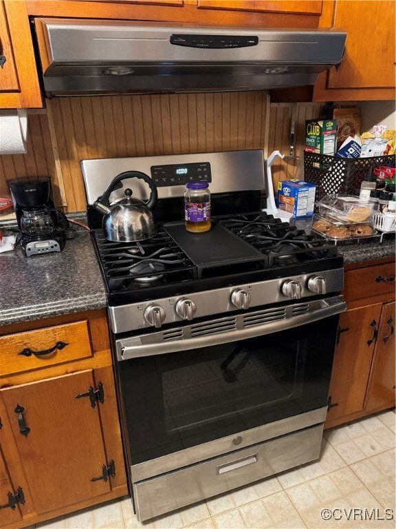 Kitchen featuring light Stainless steel range with