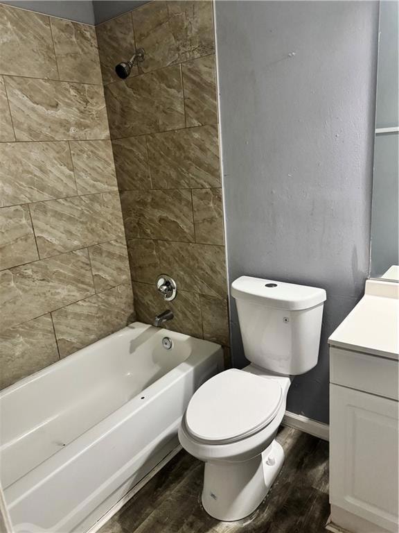 Bathroom with wood finished floors, vanity, and shower / bath combination