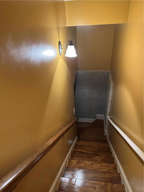 Stairway featuring hardwood / wood-style flooring