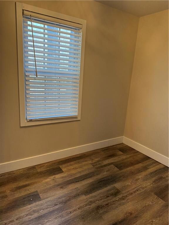 Spare room featuring dark hardwood / wood-style fl