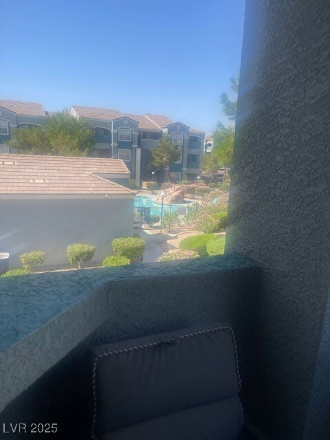 Balcony featuring view of pool
