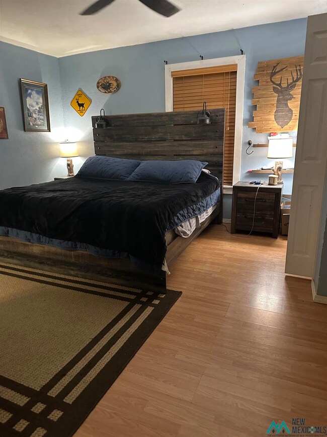 Bedroom with light wood-style flooring and a ceiling fan