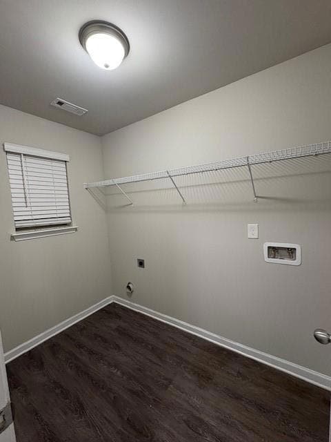 Washroom with dark wood-style floors, hookup for an electric dryer, and washer hookup