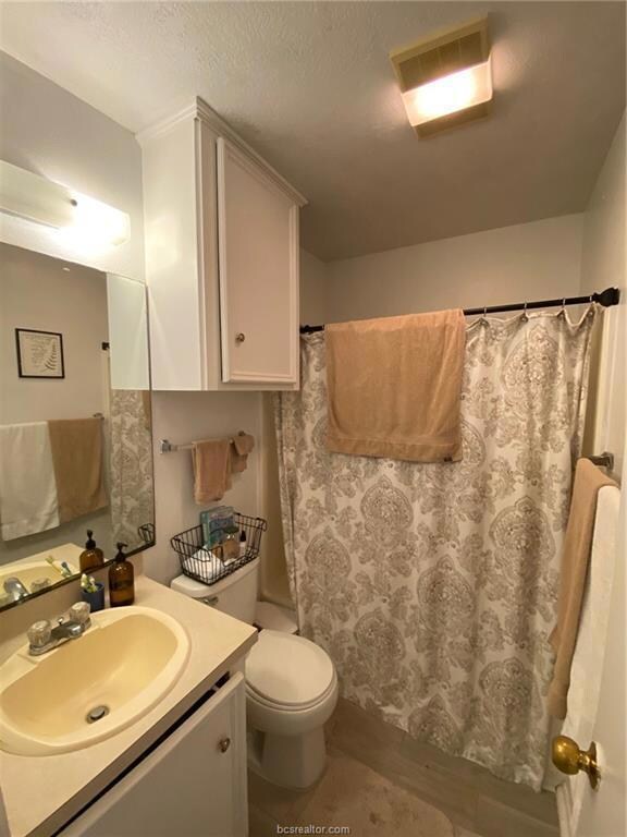 Bathroom featuring vanity, a textured ceiling, and