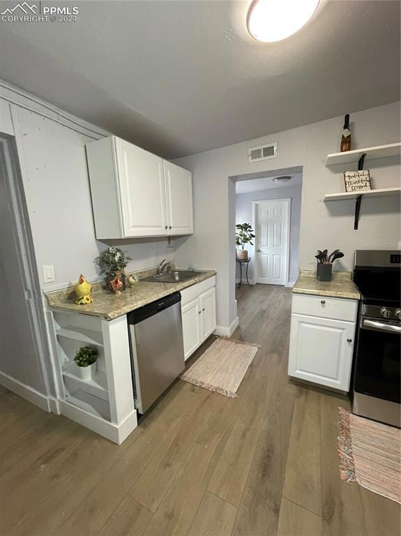 Kitchen featuring dishwasher, wood-type flooring, 
