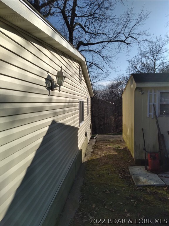 walkway between house and lawn equipment storage s