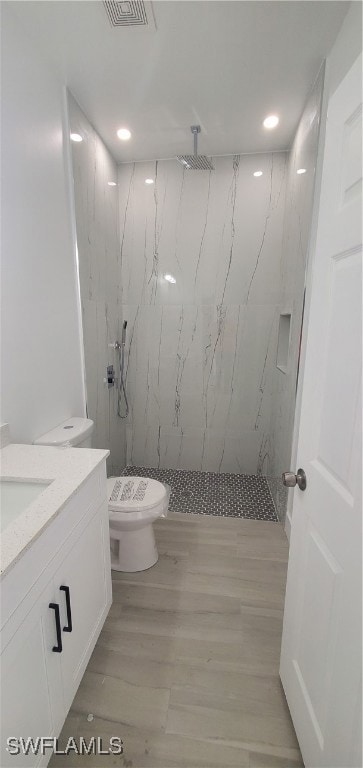 Bathroom featuring visible vents, toilet, wood fin