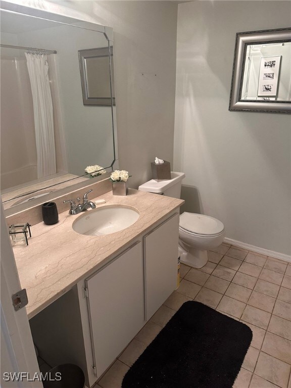 Bathroom featuring tile patterned floors, toilet,