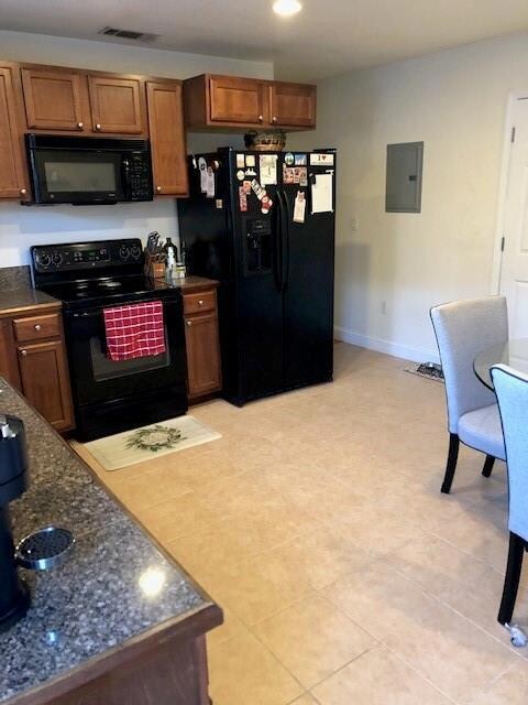 LARGE KITCHEN WITH REFRIGERATOR AND DISHWASHER. GRANITE COUNTERS AND EMPLE CABINETS.