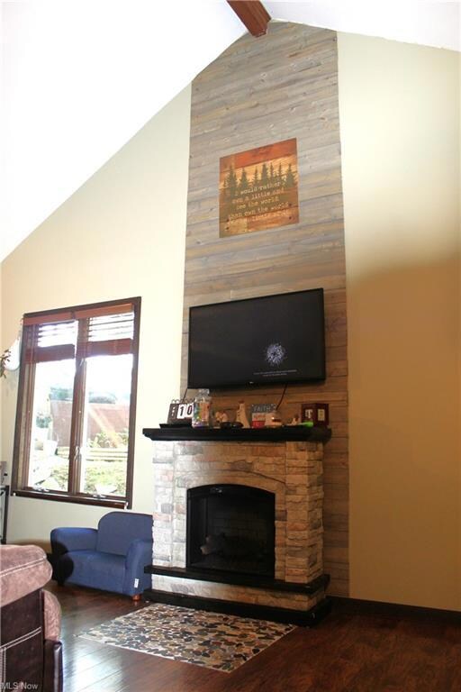 Living room with beautiful fireplace.  Vaulted cei
