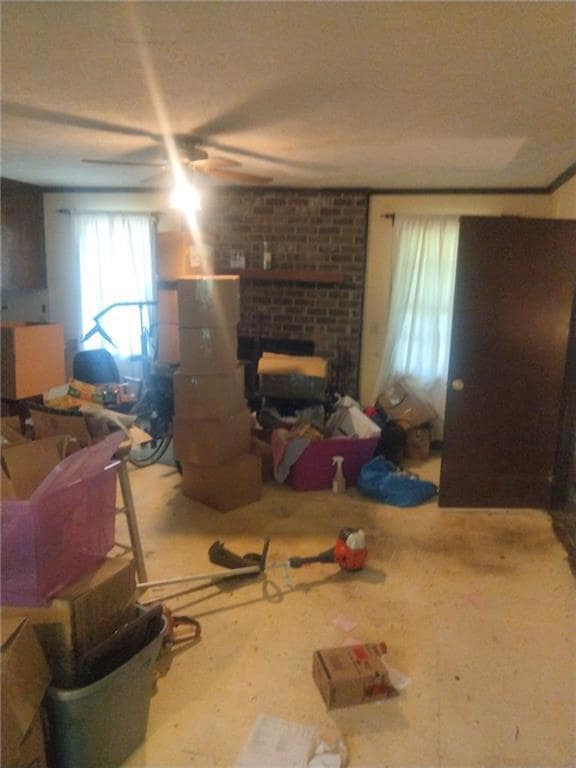 Living room with ceiling fan and a fireplace