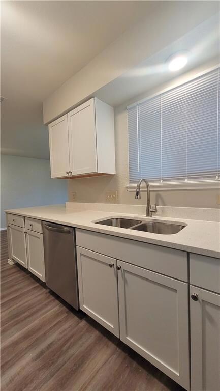 Kitchen featuring white cabinets, dark wood-style