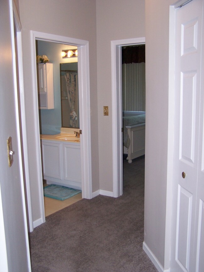 Hallway with new carpet leading to all bedrooms and guest bath