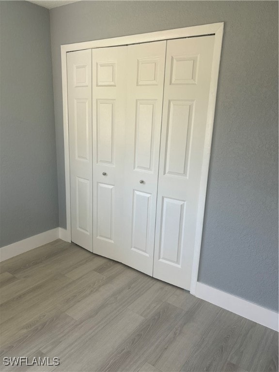 Unfurnished bedroom featuring a closet, baseboards