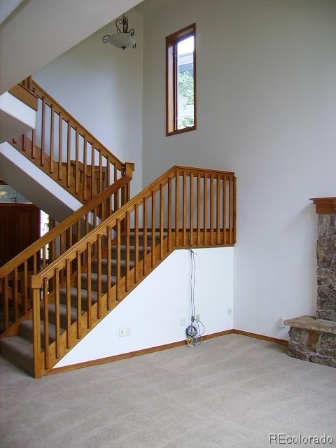 Open staircase from living room to upper level master bedroom, and guest bedroom