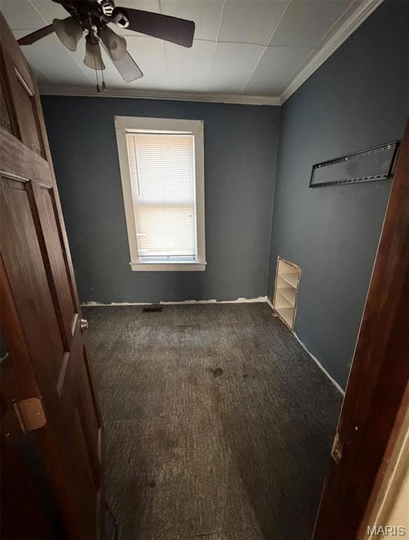 Unfurnished bedroom with crown molding, ceiling fan, and carpet