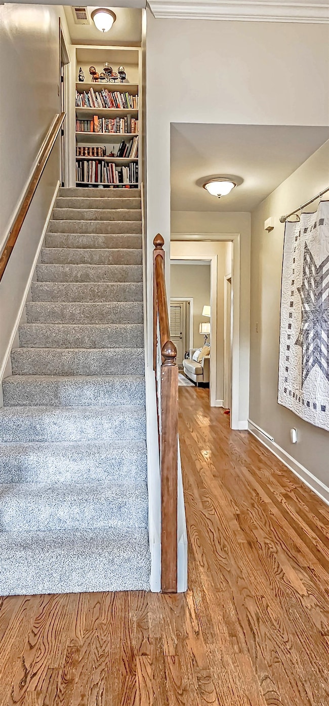 Custom bookcases at top of stairs. Pretty neutral color palette throughout.
