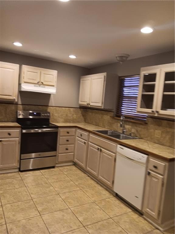 Kitchen with stove, dishwasher and disposal.