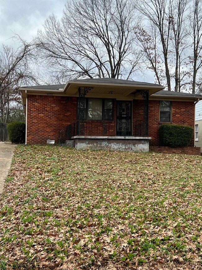 Rear view of property featuring a yard