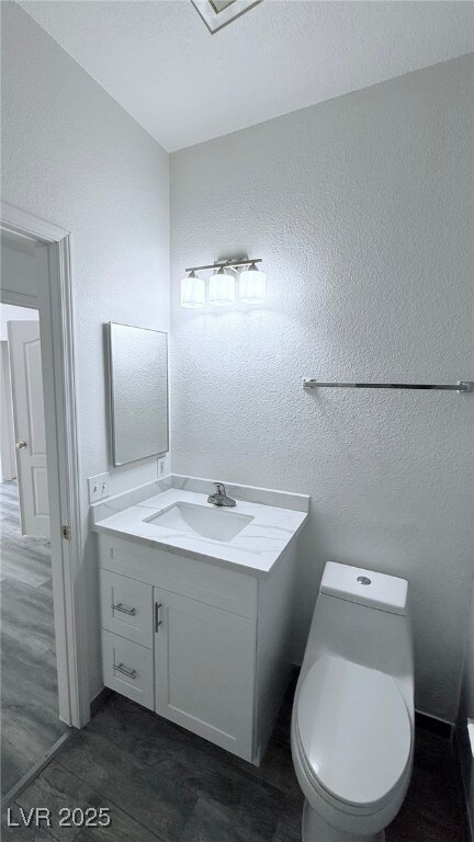 Bathroom featuring a textured wall, a textured cei