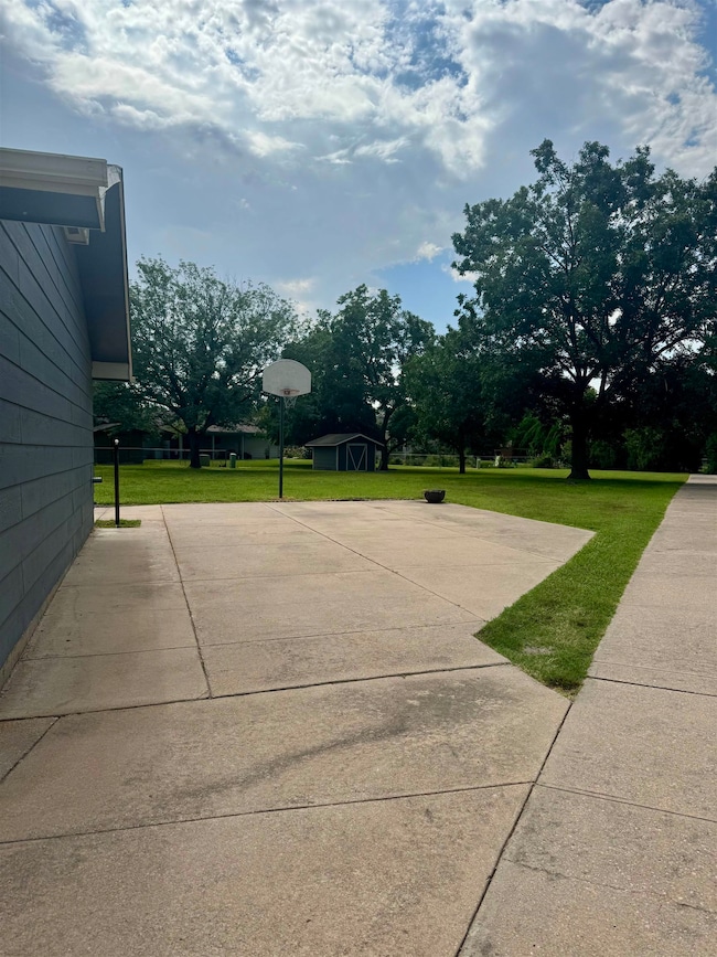 Driveway area room for additional parking or basketball court area